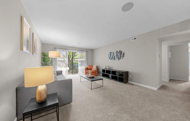 Spacious Living Room with Sliding Glass Door at Lakeside Village Apartments Clinton Township MI