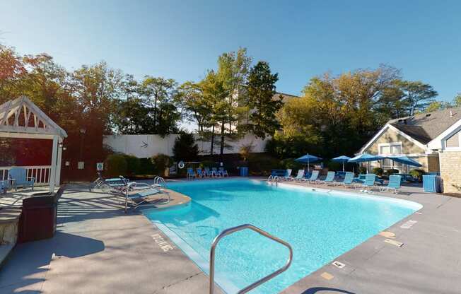 a swimming pool with chairs and a resort style pool