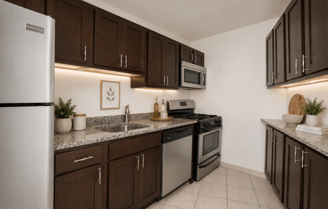 A kitchen with brown cabinets and a white refrigerator.