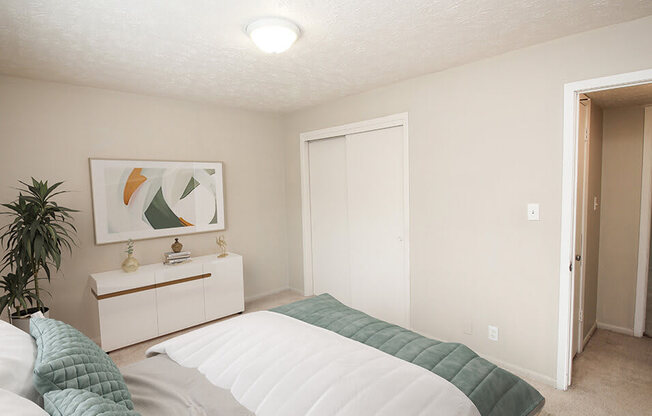 a bedroom with a bed and a dresser