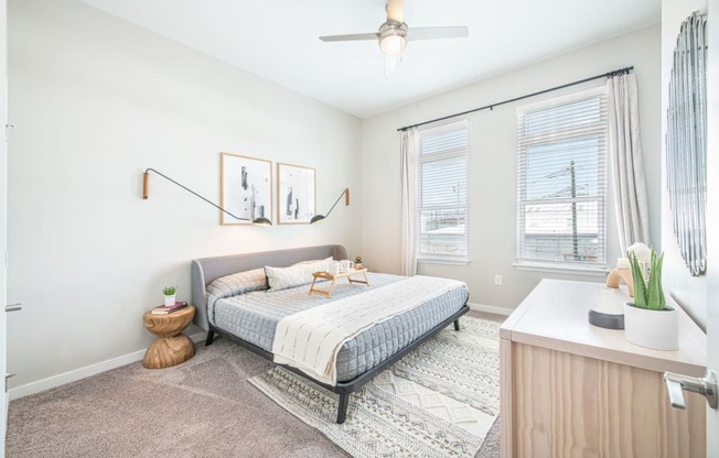 a bedroom with a bed and two windows at The Baxly, Georgia