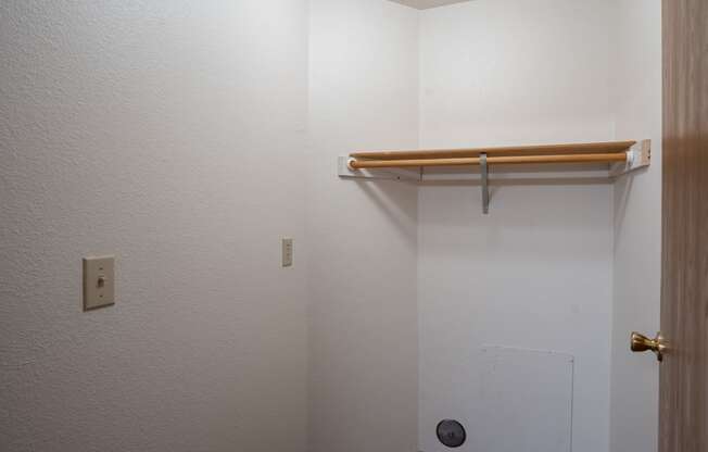 a bathroom with a shower and a hanging rail on the wall