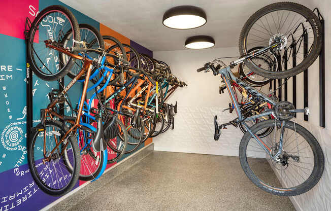 A bike shop with bikes hanging on the wall.