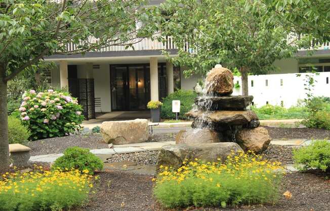 a fountain in a garden in front of a buildingat Renew Worcester, Massachusetts