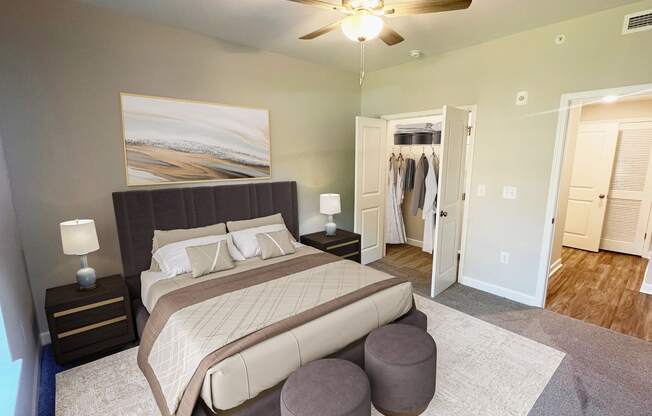 a bedroom with a large bed and a ceiling fan