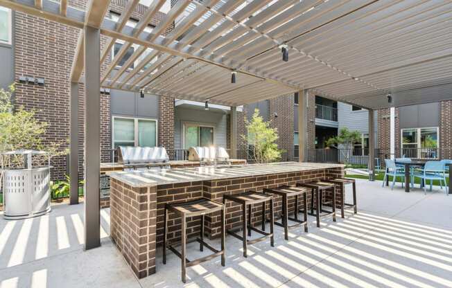 a large outdoor bar with chairs under awning