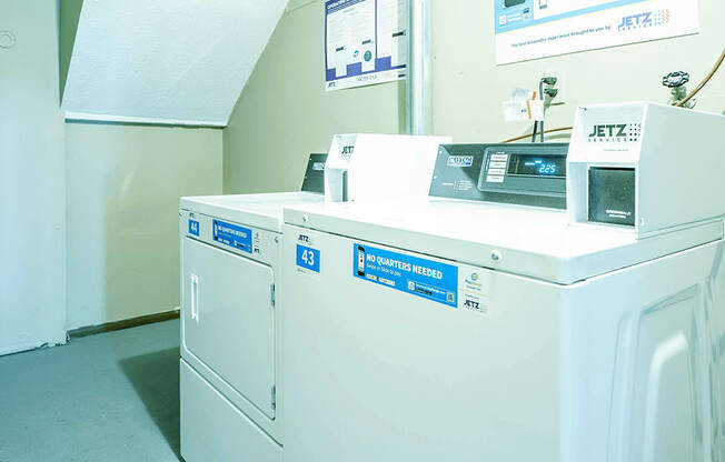 a row of washing machines in a laundromat