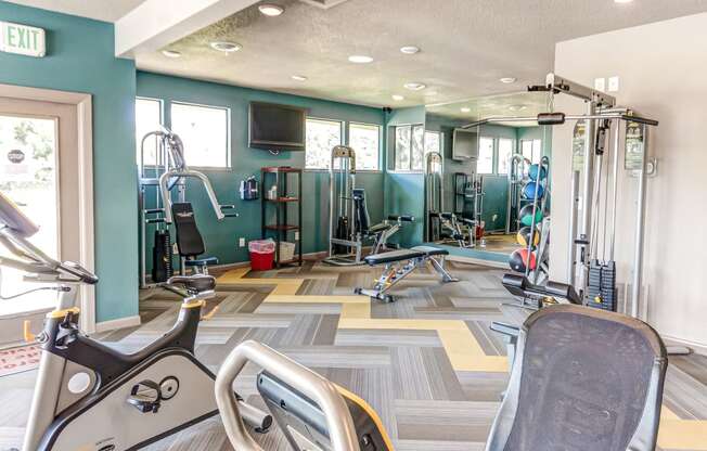 Gym with cardio machines and weights on the floor  at Union Heights Apartments, Colorado Springs, CO