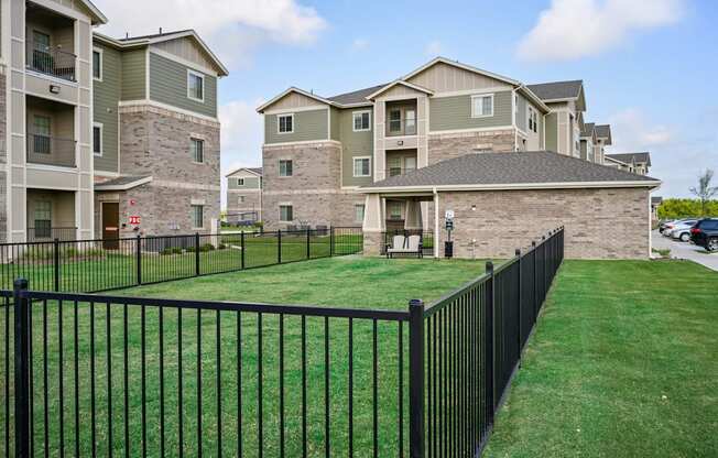 an image of an aluminum fence in front of an apartment complex