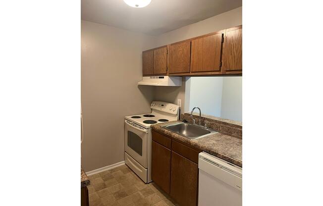 a kitchen with a sink and a mirror