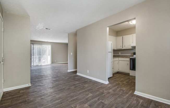 Omaha, NE Maple Ridge Apartment. A dining room with a kitchen and livingroom in the background