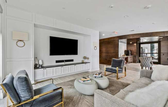 A modern living room with a grey sofa, a black chair and a white coffee table.