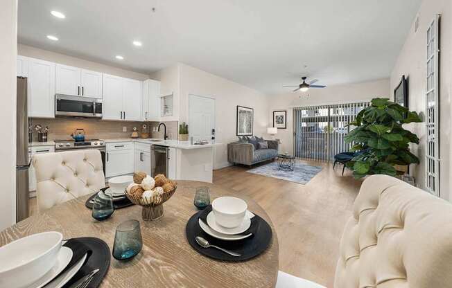 A modern kitchen with a dining table set for two.