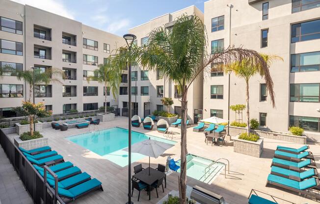 Sunny pool deck with cabanas, daybeds, and plenty of space for relaxed downtime.