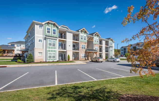 an empty parking lot in front of an apartment building