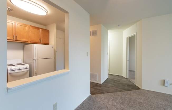 This is a photo of a large kitchen pass through and the hallway in a 560 square foot 1, 1 bath apartment at Park Lane Apartments in Cincinnati, OH.
