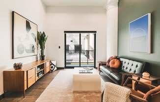 Living Room with a Green Wall and Leather Sofa at The May, Cleveland, Ohio