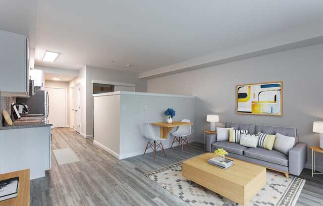 a living room with a gray couch and a wooden coffee table