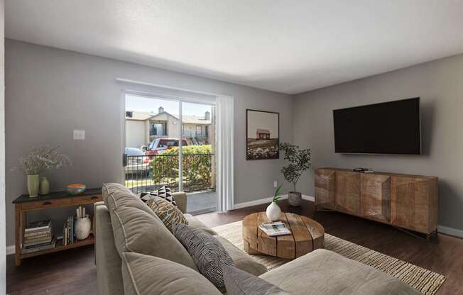 A living room with a large couch and a flat screen TV.