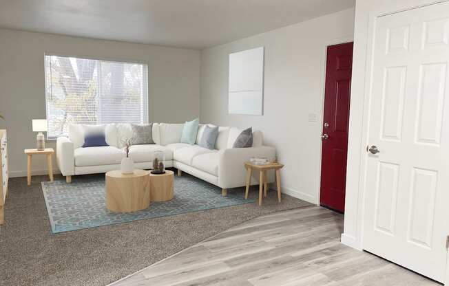 Living room with oversized window on back wall, front door, and closet on right. Staged with l-shaped couch, side tables, rug.at Summit, Pocatello, ID 83201