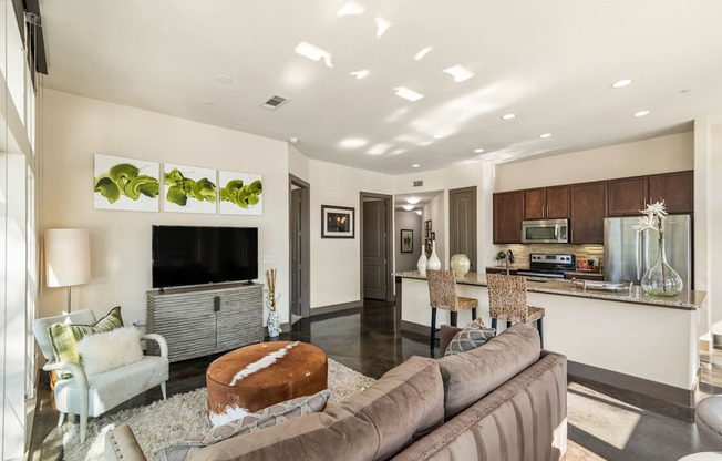 A modern living room with a brown couch and a white chair.