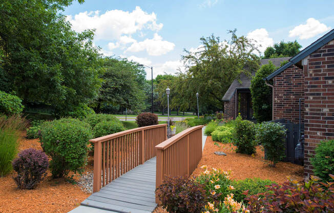 Landscaping and bridge leading to the leasing office and clubhouse at Eden Commons in Eden Prairie, MN 55344