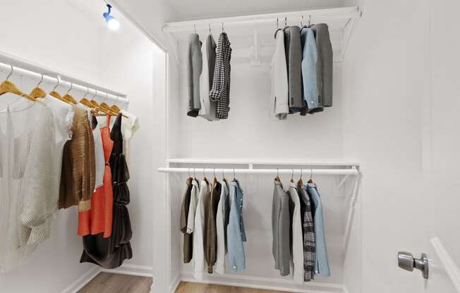 a closet with a rack of clothes on the wall