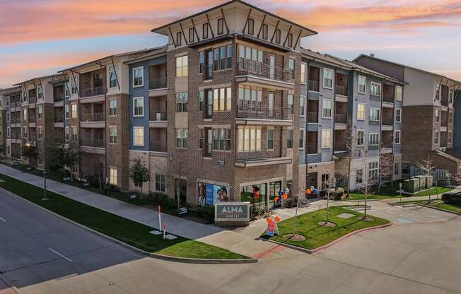Apartment complex with a sign that says "ALMA".
