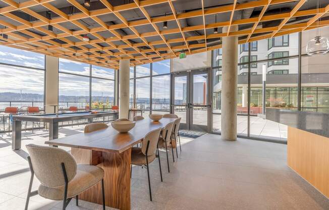 a dining area with a long wooden table and chairs at Marina Square, Washington, 98337