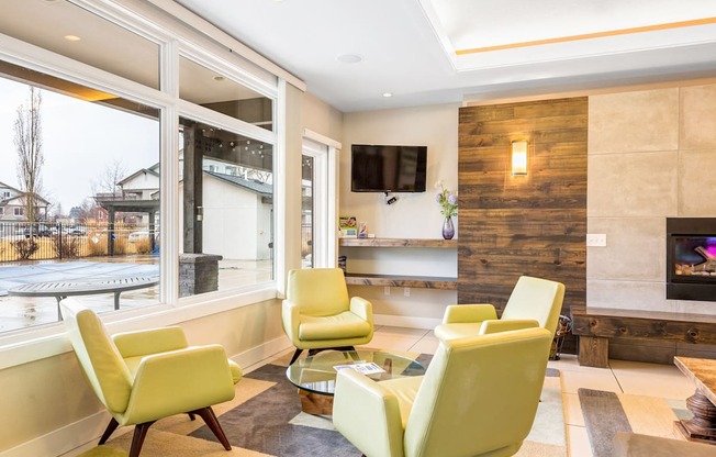 a living room with yellow chairs and a fireplace