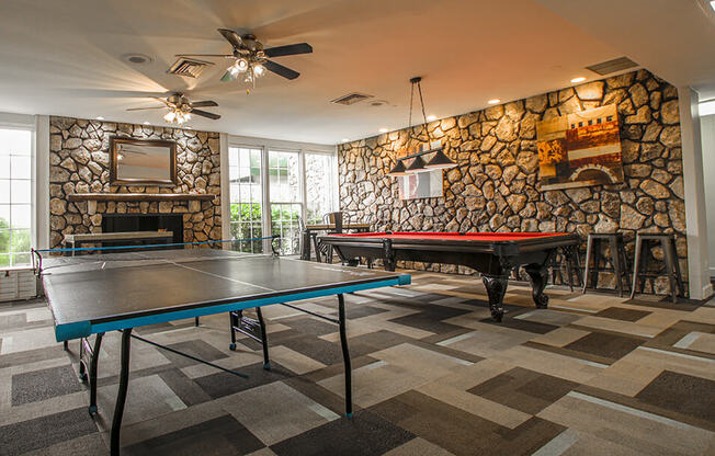 a game room with a pool table and ping pong