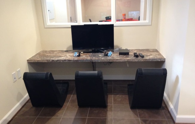 resident gaming station with monitor, game controllers, and fun chairs at fairway park apartments in washington dc