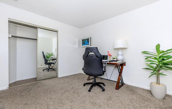 carpeted bedroom with sliding mirror glass closet doors