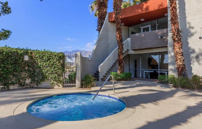 a house with a pool in front of a building