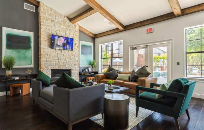 a living room with couches and chairs and a fireplace