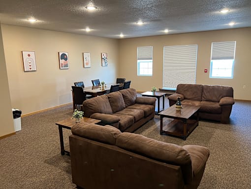 a living room with couches and tables at Bluemont Village Apartments, Fargo