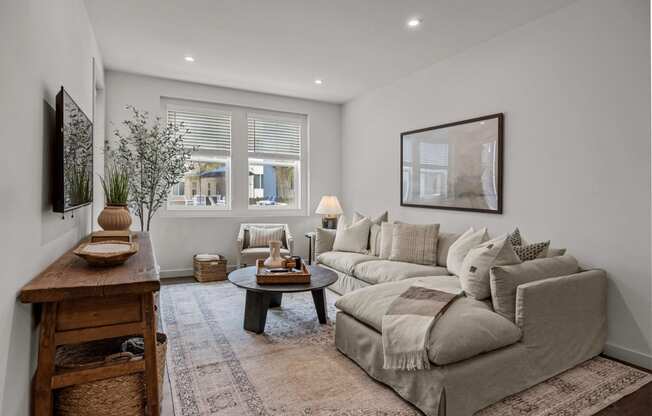 a living room with a couch and a tableat Westbury Apartments, Rancho Cucamonga, 91739