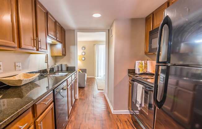 a kitchen with wooden cabinets and stainless steel appliances at Broadway at East Atlanta,Georgia