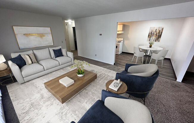 A living room with a white couch, a coffee table, and a painting on the wall.