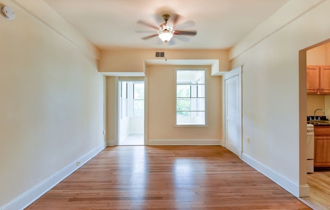 vacant living area with large windows, hard wood flooring and ceiling fan  at twin oaks apartments columbia heights washington dc