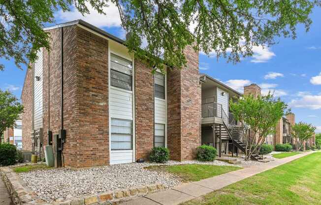 A brick building with a white door and windows.
