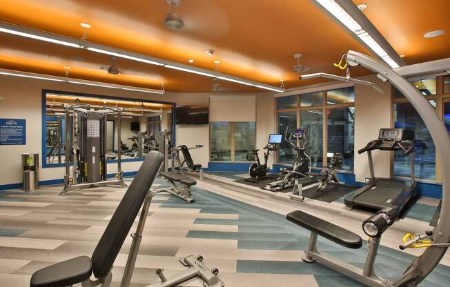 a gym with weights and a sign that says the gym is filled with weights