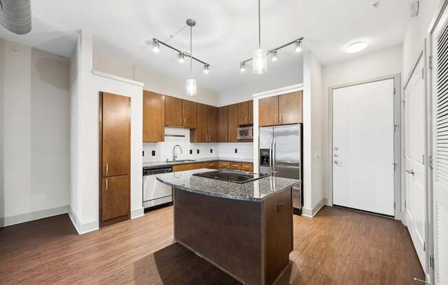 A kitchen with wooden cabinets and a central island.