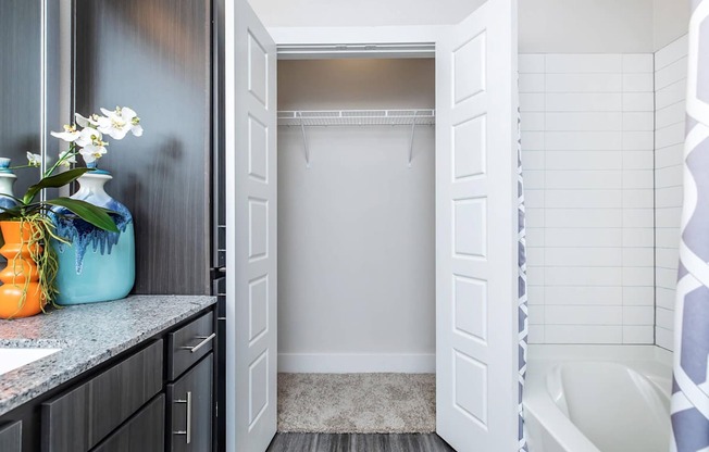 A bathroom with a white tub and a white door.
