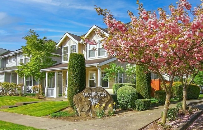 a large house with a sign in front of it