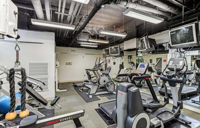 A gym with a variety of equipment including treadmills and exercise bikes.