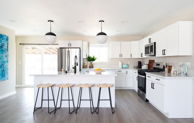 Stunning 4 Bed / 2 Bath with Chef’s Kitchen, In-Unit Laundry and Shared Backyard Retreat