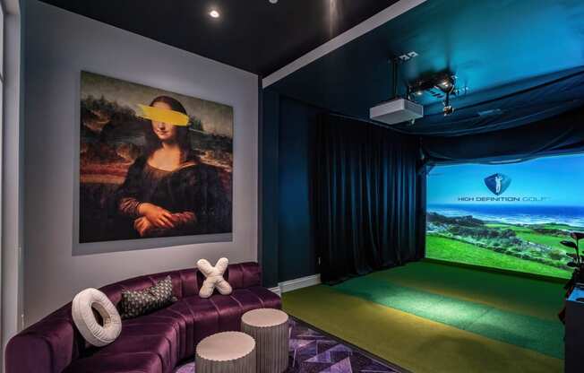 a home theater with a purple couch and a large painting on the wall at Altis Grand Lake Willis, Orlando, 32821