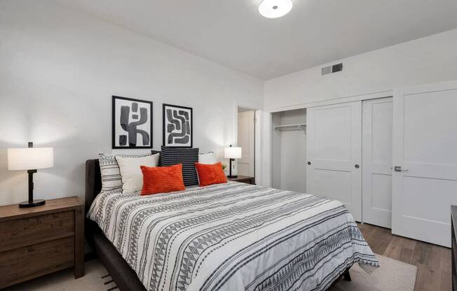 a bedroom with a large bed and white closets