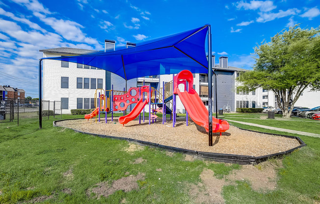 a playground with a blue canopy